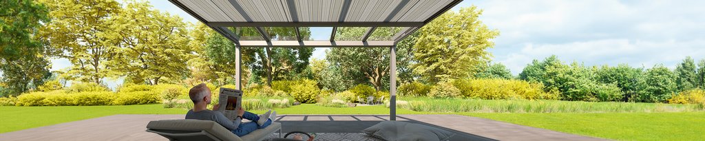 A relaxed couple sits beneath an overhead structure, surrounded by greenery and trees in a bright outdoor setting. A relaxed couple sits beneath an overhead structure, surrounded by greenery and trees in a bright outdoor setting.
