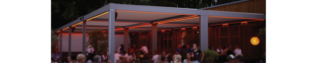 Stylish outdoor seating area with a modern overhang and warm ambient lighting. Stylish outdoor seating area with a modern overhang and warm ambient lighting.