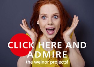 A surprised woman with red hair excitedly shows her enthusiasm against a grey background. 